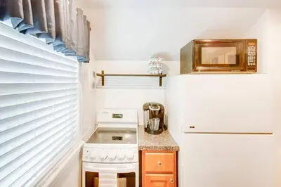 a small kitchen with a refrigerator and a sink at Off The Beaten Path - Choose This Private Gem in Devon