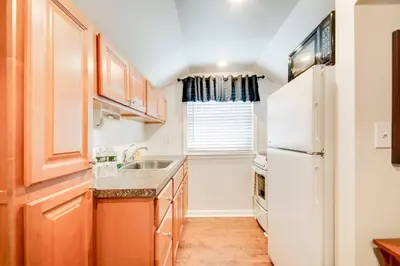 a kitchen with a white refrigerator and a sink at Off The Beaten Path - Choose This Private Gem in Devon