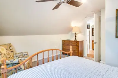 a bedroom with a bed with a ceiling fan and a chair at Off The Beaten Path - Choose This Private Gem in Devon