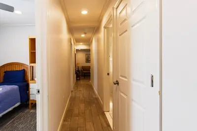 a hallway leading to a bedroom with a bed and a door at Devon - Horse Show, History, Walk to Shops, Café's in Devon