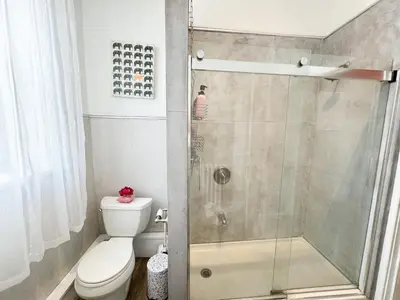 a bathroom with a shower and a toilet at NYC views Spacious 3 bedroom apartment in Union City