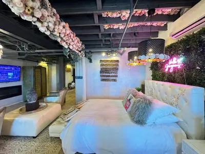 a room with a large bed and a couch at Amazing views of NYC and Patio 10 mins from NYC in Union City