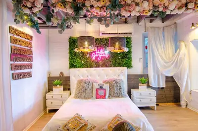 a bedroom with a bed with flowers on the wall at Amazing views of NYC and Patio 10 mins from NYC in Union City