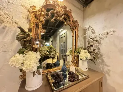 a mirror on a table with vases and flowers at Amazing views of NYC and Patio 10 mins from NYC in Union City
