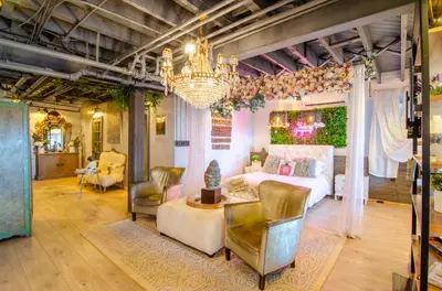 a bedroom with a bed and a chandelier at Amazing views of NYC and Patio 10 mins from NYC in Union City
