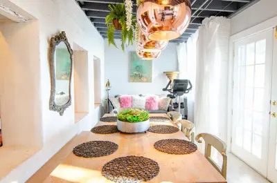 a dining room with a table with chairs and a chandelier at Amazing views of NYC and Patio 10 mins from NYC in Union City