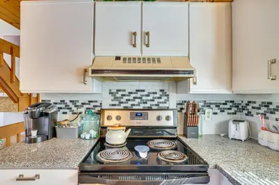 a kitchen with white cabinets and a stove top oven at Walk to Beach Arrowhead Lake Home in Pocono Lake