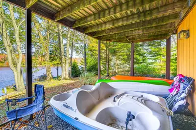 a bath tub sitting on the side of a house at Walk to Beach Arrowhead Lake Home in Pocono Lake