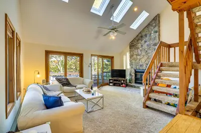 a living room with a couch and a fireplace at Walk to Beach Arrowhead Lake Home in Pocono Lake
