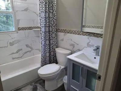 a bathroom with a toilet and a sink at Two-Bedroom Home Private Parking 25 min to NYC in Teaneck