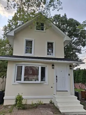 a white house with a white door and windows at Two-Bedroom Home Private Parking 25 min to NYC in Teaneck