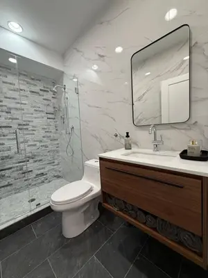 a bathroom with a toilet and a sink and a shower at Sustainable Apartment In University City in Philadelphia