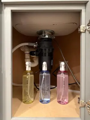 three different colored bottles sitting under a camera at Sustainable Apartment In University City in Philadelphia