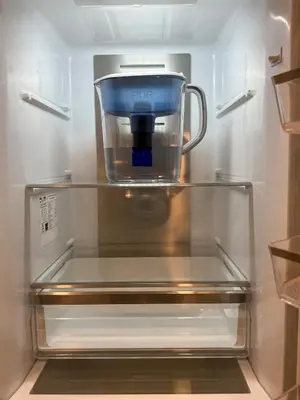 a food processor sitting on a shelf in a refrigerator at Sustainable Apartment In University City in Philadelphia