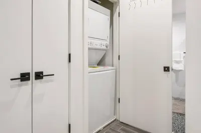 a kitchen with white cabinets and an open refrigerator at Charming 1BR King Bed - Just 20 Minutes from NYC! in Newark