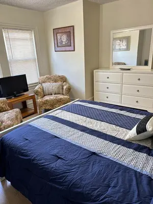a bedroom with a blue bed and a dresser at Beautiful House for Rent in Philadelphia