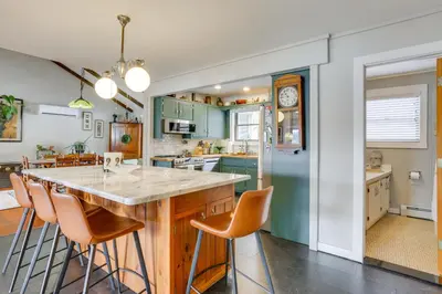 a kitchen with green cabinets and a large island at Waterfront Home on White Lake Near Bethel Woods! in White Lake