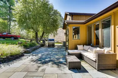 a patio with a couch and chairs on a house at Waterfront Home on White Lake Near Bethel Woods! in White Lake
