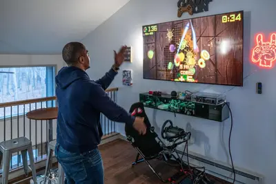 a man playing a video game on the nintendo wii at Luxurious Poconos Retreat - Hot Tub, Sauna, Games in East Stroudsburg