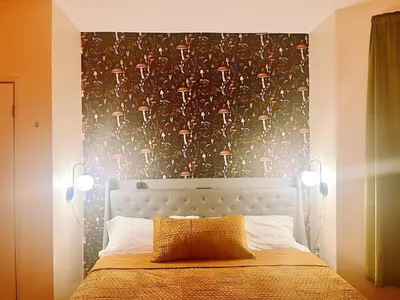 a bedroom with a bed with a headboard and two lights at 3 bdrm stay! Trippy King Suite by Dwtwn Nwk in Newark