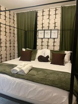a large white bed with two towels on it at 3br 3bath Duplex NY 23 mins in Hoboken