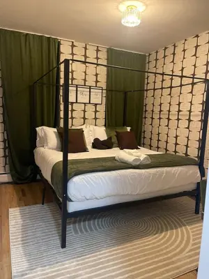 a bedroom with a bed with a metal frame at 3br 3bath Duplex NY 23 mins in Hoboken