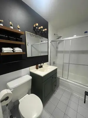 a bathroom with a toilet and a sink and a shower at 3br 3bath Duplex NY 23 mins in Hoboken