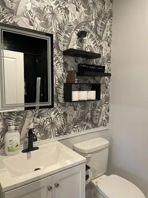 a bathroom with a sink and a toilet with a wallpaper at 4br 5ba 4 Car Parking Bonus Rm and Back Yard in East Newark