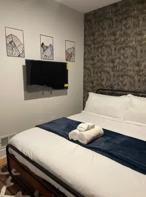 a bedroom with a bed with a towel on it at 4br 5ba 4 Car Parking Bonus Rm and Back Yard in East Newark