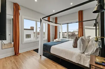 a bedroom with a bed and a large window at 2br 3ba 2King bd 3 Car Parking Bonus area with Queen Bed in East Newark
