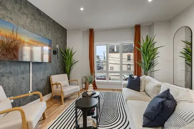 a living room with a couch and a table at 2br 3ba 2King bd 3 Car Parking Bonus area with Queen Bed in East Newark