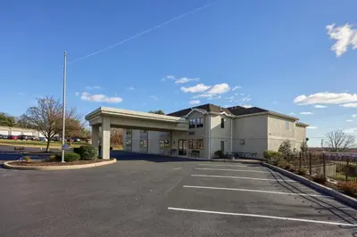 a large white building with a parking lot at Lititz Pointe Inn and Suites in Lititz