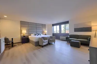 a bedroom with a bed and a couch and a desk at Lititz Pointe Inn and Suites in Lititz