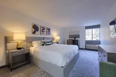 a bedroom with a large white bed and a desk at Lititz Pointe Inn and Suites in Lititz