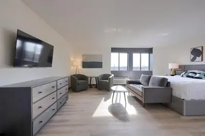 a bedroom with a bed and a couch and a tv at Lititz Pointe Inn and Suites in Lititz
