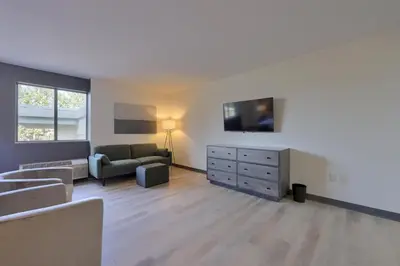 a living room with a couch and a dresser at Lititz Pointe Inn and Suites in Lititz