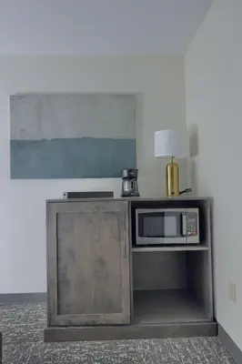 a microwave on a cabinet with a lamp on it at Lititz Pointe Inn and Suites in Lititz