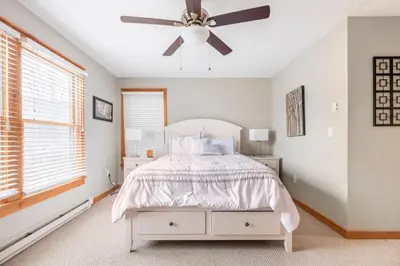 a bedroom with a bed and a ceiling fan at Your Gateway to Pocono! in Tannersville
