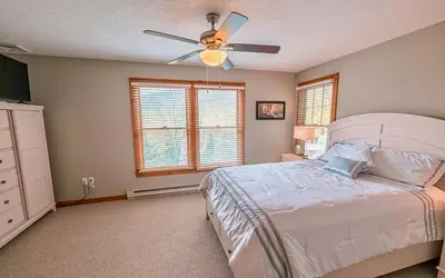 a bedroom with a bed and a ceiling fan at Your Gateway to Pocono! in Tannersville