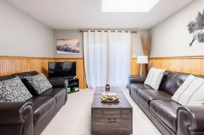 a living room with a leather couch and a coffee table at Your Gateway to Pocono! in Tannersville