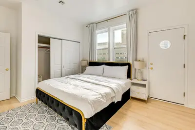 a bedroom with a large bed and a window at 1 Mi to Prudential Center Remote Work-Ready Apt in Newark