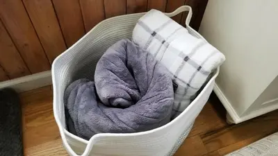 a white basket with a blanket and a pillow at 1 floor, Pocono Pond house with Game Room in Tobyhanna