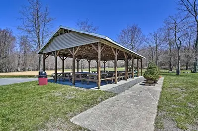 a pavilion with picnic tables in a park at 1 floor, Pocono Pond house with Game Room in Tobyhanna