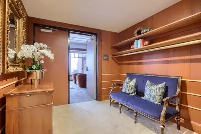 a living room with a blue couch and a mirror at The Executive Suites and Events in Ephrata