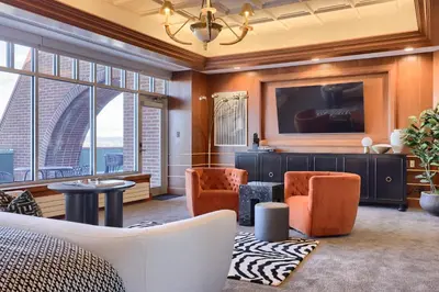 a living room with a couch and chairs and a tv at The Executive Suites and Events in Ephrata