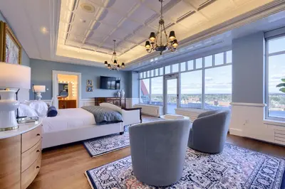 a bedroom with a bed and a large window at The Executive Suites and Events in Ephrata
