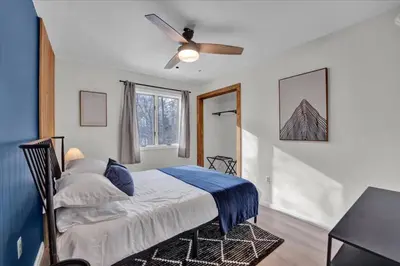 a bedroom with a bed and a ceiling fan at Lakefront Movie Theater, Hot Tub, Arcade, Boats in Gouldsboro