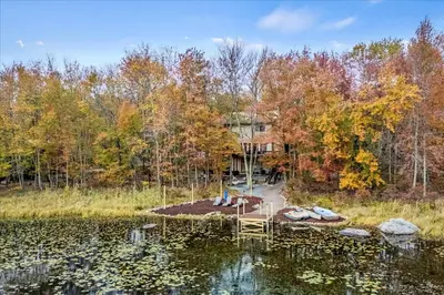 a house in the middle of a lake at Lakefront Movie Theater, Hot Tub, Arcade, Boats in Gouldsboro