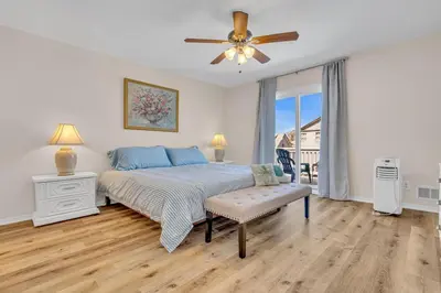 a bedroom with a bed and a ceiling fan at Bayview Coastal Home - Steps to Shore & Free Parking in Keansburg