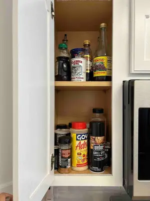 a cupboard filled with lots of food and spices at Bayview Coastal Home - Steps to Shore & Free Parking in Keansburg